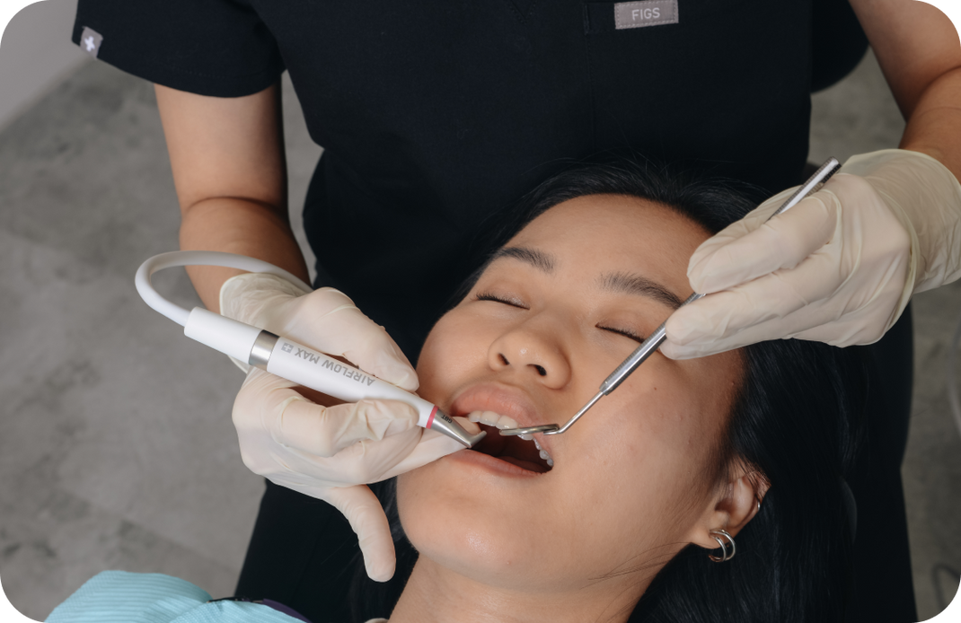 Photo of a woman getting scaling treatment with EMS Airflow Guided Biofilm Therapy